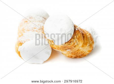 Two small delicious cream rolls on a white background