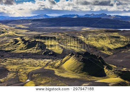 Dramatic Iceland Landscape Of Craters Of Laki Volcanic Fissure With A Green Hill And Black Lava Look