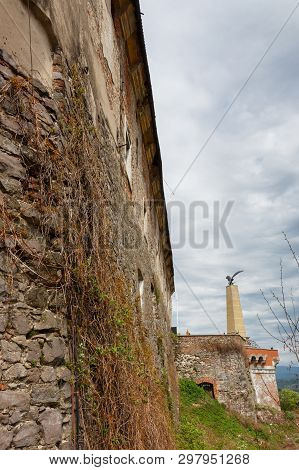 View On The Exterior Of Palanok Castle In Mukachevo. External Wall Foreground With Statue Of Mythica