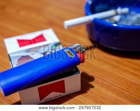 Miercurea Ciuc, Romania- 27 April 2019: Blue Bic Lighter On A Pack Of Marlboro Cigarette.
