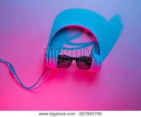 Sunglasses With Headphones. Retro Wave, Blue Pink Neon Light, Ultraviolet. Top View, Minimalism