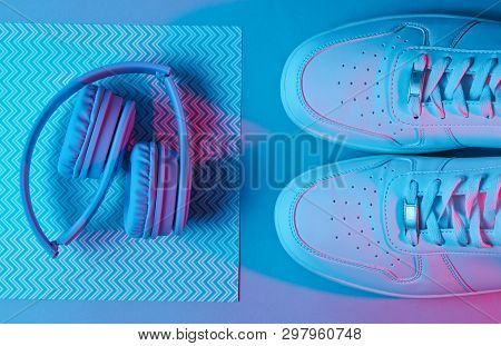 Sneakers And Headphones. Retro Wave, Neon Light, Ultraviolet. Top View, Minimalism