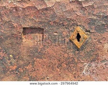 Old Weathered Chappy Door With Rusty Keyhole