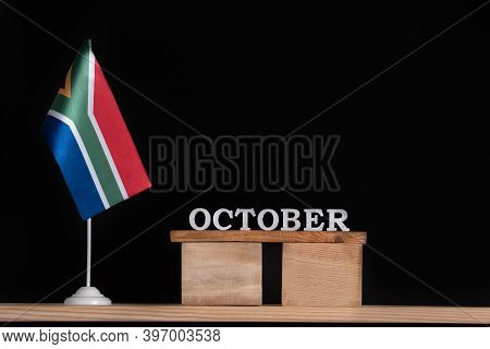 Wooden Calendar Of October With Rsa Flag On Black Background. Dates Of South Africa In October