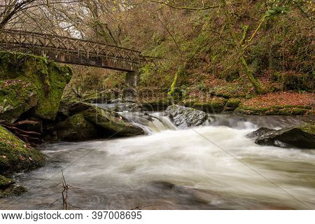 Long Exposure Of The East Lyn River Flowing Under A Bridge At Watersmeet In Exmoor National Park In 