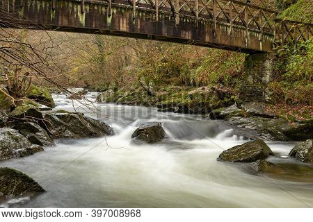 Long Exposure Of The East Lyn River Flowing Under A Bridge At Watersmeet In Exmoor National Park In 