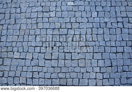 Detail Of Tiles Made Of Small Cubes Of Gray-blue Color Laid In Rows Straight View From The Top