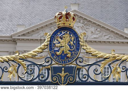 The Hague, The Netherlands - May 15 2020. A View Of A Coat Of Arms With A Crown, On The Fence In Fro