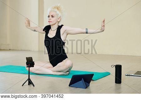 Pretty Female Dancer Doing Back And Arms Exercise When Filming Herself Training For Social Media