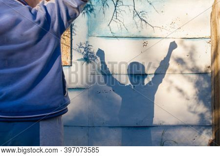The Shadow Of A Child On The Fence, The Boy Raised His Hands In Victory