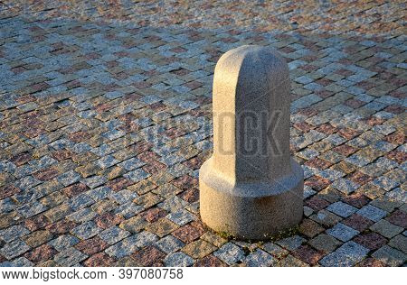 A Granite Decorative Bollard On A Square Of Bright Granite Color Around A Granite Bar In A Paving Pi