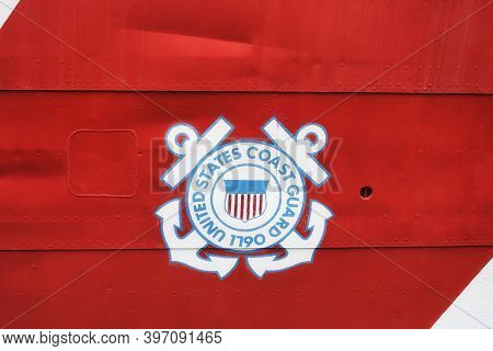 The Iconic Coast Guard Symbol On A Red Banner On The Outside Of A Ships Hull In Baltimore Maryland I