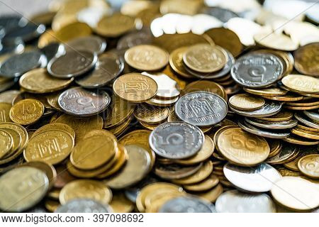Collectible Coins Scattered On A Surface. Golden And Silver Coins. View From Above.
