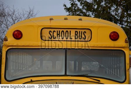 Detail Of School Bus From America Yellow Color Front View Of Window Lights And Bus Sign In Letters