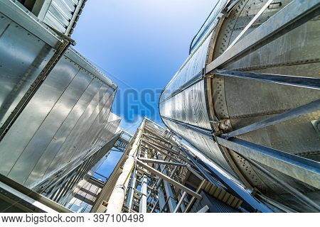 Industrial Agriculture Elevators With Harvested Grain. Grain Cooperative. Closeup.
