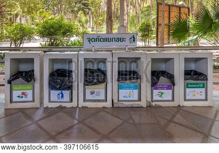 Different Colored Bins For Collection Of Recycle Materials. (translate : (top) Waste Separation Poin