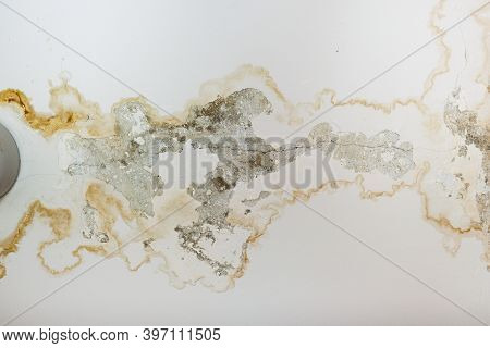 Rain Water Leaks On The Ceiling Because Of Damaged Roof Causing Decay, Peeling Paint And Moldy, Clos
