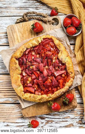 Galette With Strawberry And Rhubarb. Homemade Tart, Tarte. White Wooden Background. Top View