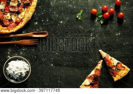 Pizza Pieces Salt And Tomatoes On Black Table