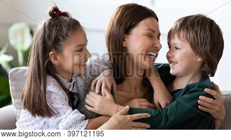 Two Children Hug Embrace Happy Mom Showing Love