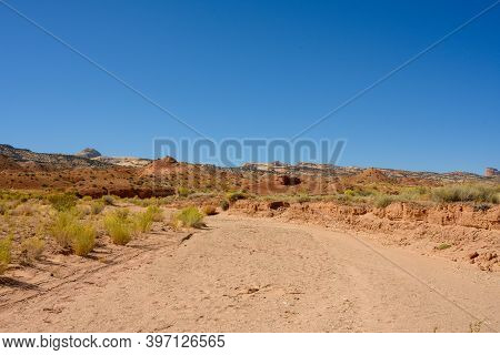 Standing In A Wash On A Blue Sky Day In Capitol Reef National Park