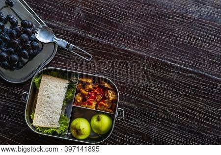 Healthy Vegetarian Meal In Eco-friendly Stainless Metal Food Container Or Lunch Box With Spork On Wo