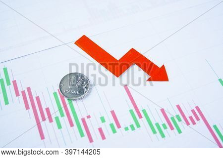 One Rouble Coin On Currency Graph With Red Arrow Down. Exchange Rate Chart. Ruble Depreciation. Exch