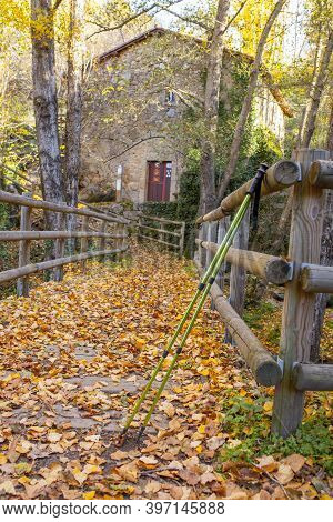Trekking Poles At Old Banos De Montemayor Watermill. Magic Autumn Of Ambroz Valley, Extremadura, Spa