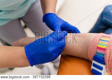 Doctor Drawing Blood Sample From Arm For Blood Test. Selective Focus.