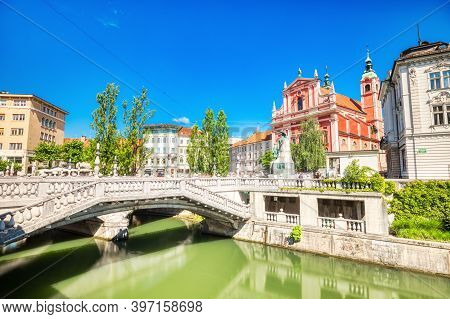 Ljubljana City Center During A Sunny Day Overlooking The Triple Bridge And Beautiful Franciscan Chur