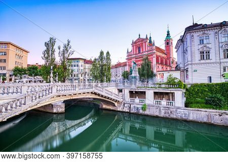 Ljubljana City Center At Dusk Overlooking The Triple Bridge And Beautiful Franciscan Church, Sloveni