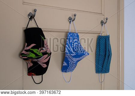 Covid-19 Cloth Face Masks Hanging On Door Hooks At Home Ready To Wear Before Leaving The House. Side