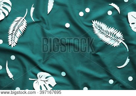Tidewater Green Color. Creative Trendy Flat Lay With Exotic Paper Leaves On Dark Textile Background