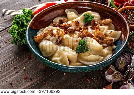 Pierogi Or Pyrohy, Varenyky, Vareniki, Dumplings Served With Caramelized Salted Onion In Bowl On Woo