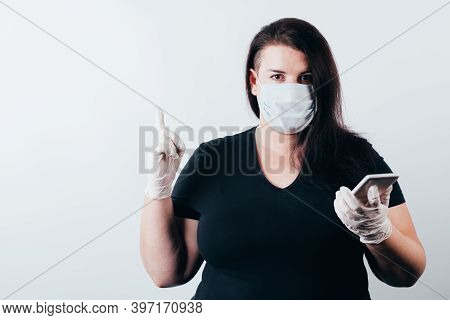 Insight. Important Information. Attention Gesture. Surprised Woman In Medical Mask And Gloves Holdin