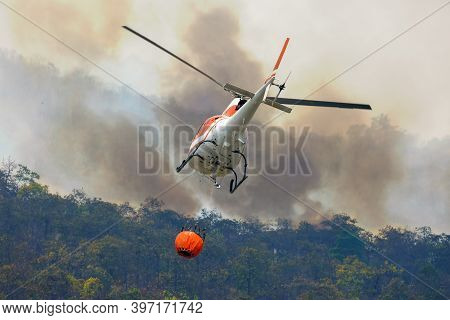 Firefithing Helicopter Dumps Water On Forest Fire
