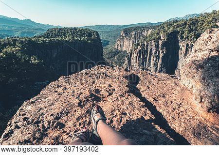 Greyhound Canyon View. Blurry Woman Resting With Her Legs Outstretched On The Stone. Tazi Canyon.