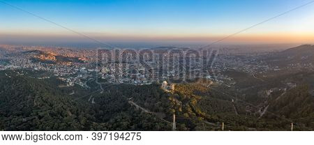 Panorama Aerial Drone Shot Of Tibidabo Mountain With City View Of Barcelona During Sunset