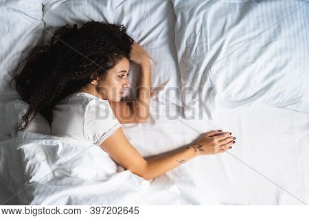 Afro-haired Upset Woman Alone In Bed With Empty Space Next To Her. Divorse, Loss Of Loved One Concep