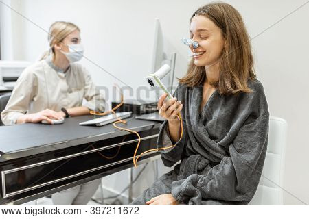 Young Woman With Doctor During A Spirography Test, Measuring Breathing Movements With Spirometer At 