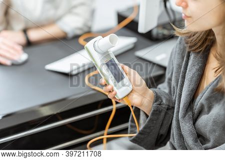 Patient Holding Spirometer, Medical Instrument For Measuring Breathing Movemnts, Close-up