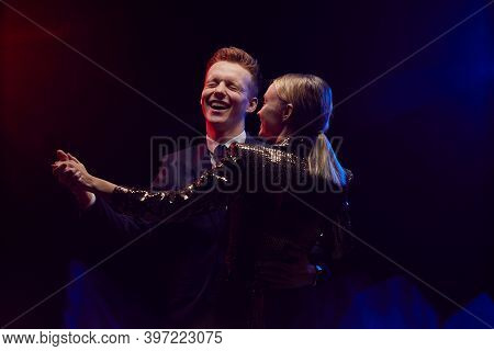 Waist Up Portrait Of Happy Young Couple Dancing Together While Enjoying Party At Prom Night Against 