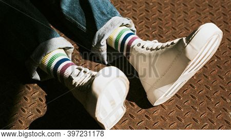 High top white sneakers on model casual style