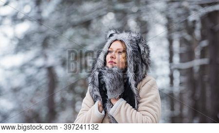 Girl In Snowy Forest. Faux Fur Animal Hat Perfect For Fantasy Theme. Heartwarming Concept. Animal Ca