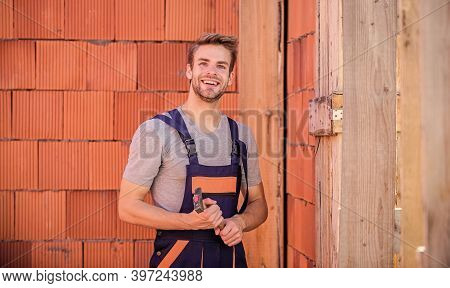 Builder Enjoy Success. Worker Brick Wall Background. Building And Construction. Man Builder In Work 