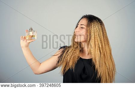 Be Yourself. Pretty Woman Hold Perfume. Elegant Smell. Cosmetic Care. Woman With Bottle Of Perfume. 