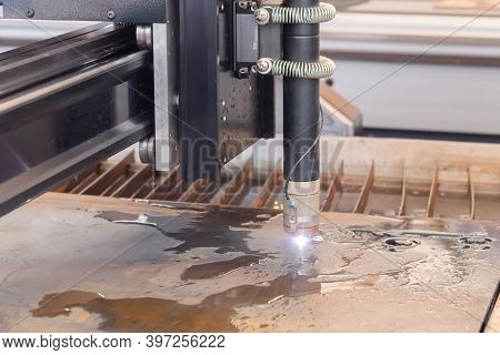 Automatic Cnc Plasma Cutting Machine Working With Sheet Metal With Sparks At Factory, Plant. Metalwo