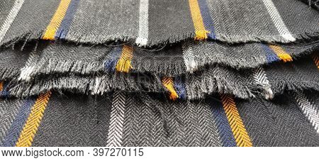 Gray-black Fabric With Orange And Blue Stripes. Textile Fabric Folded Neatly On The Surface. Natural