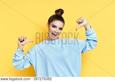 Young Happy Wman Pointing To Herself Isolated Over Yellow Background. Emotions Concept