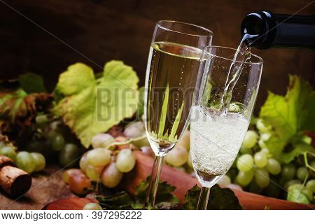 Champagne Pour In Glass, Grapes With Vine, Vintage Wood Background, Selective Focus